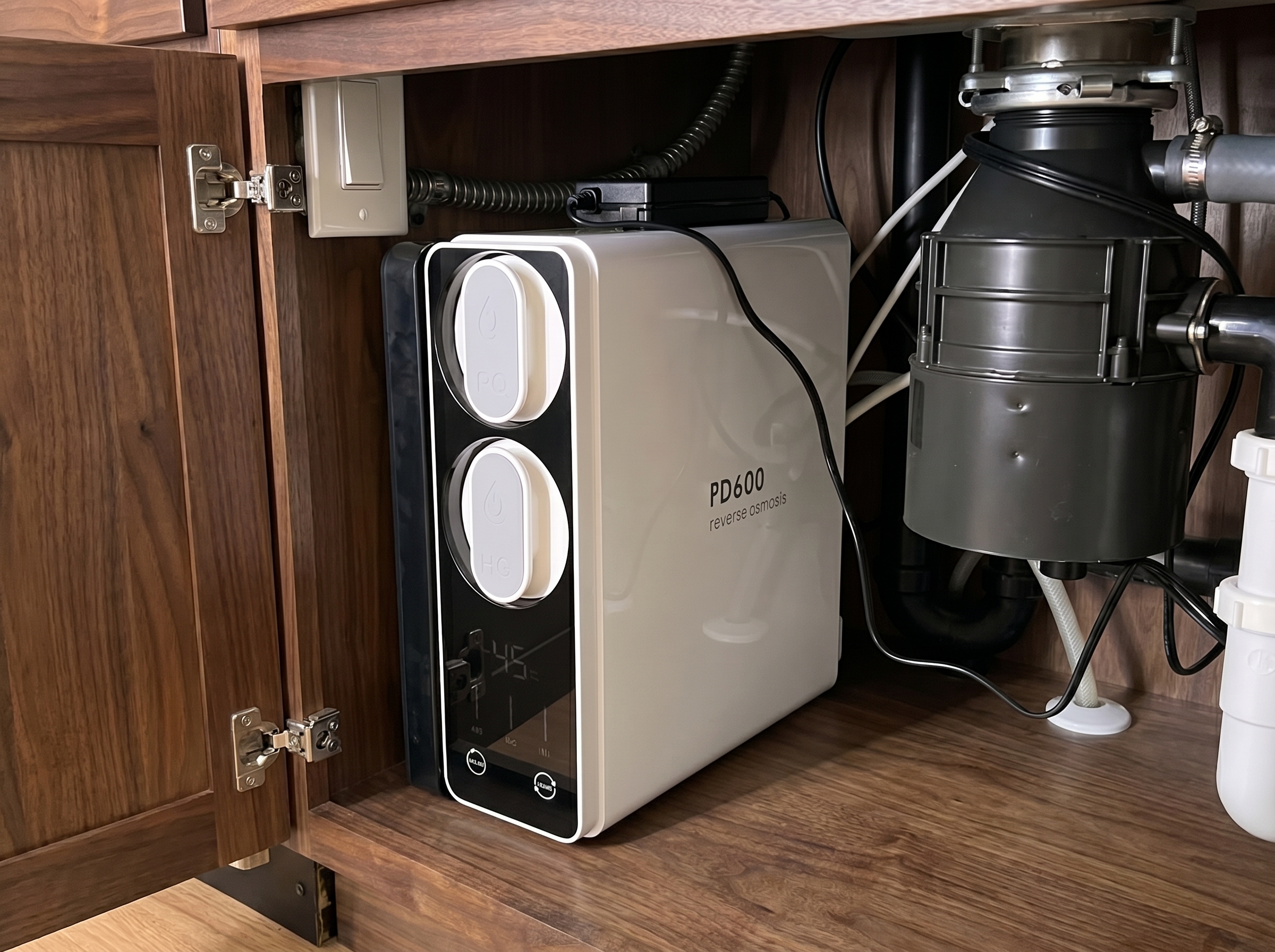 Frizzlife PD600 installed under kitchen sink in North Alabama home &mdash; TDS display reading 45 PPM, garbage disposal visible to the right
